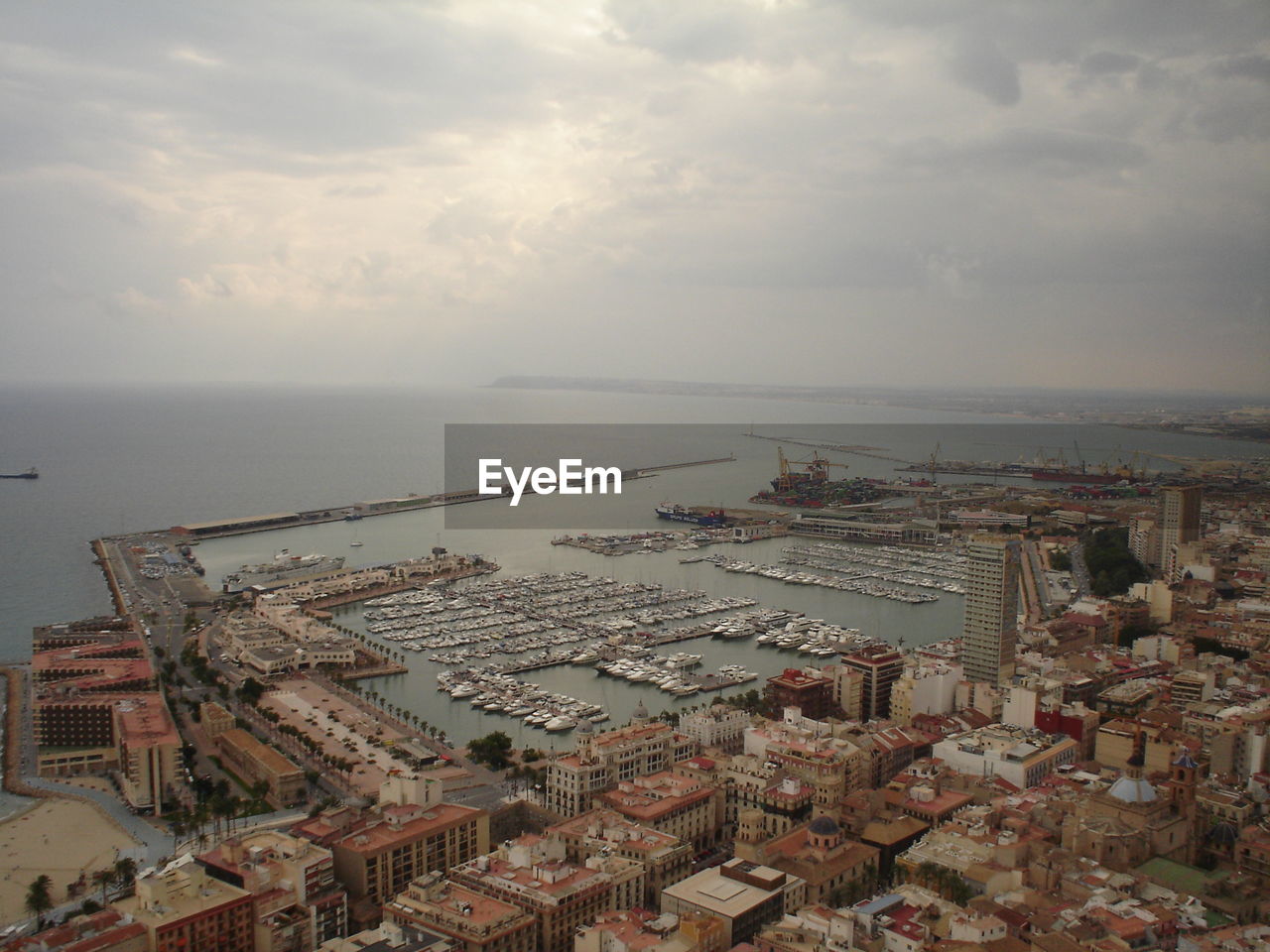 High angle view of cityscape by sea against sky