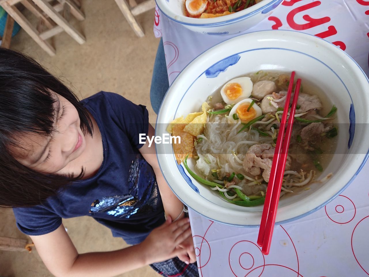 HIGH ANGLE VIEW OF GIRL HAVING FOOD