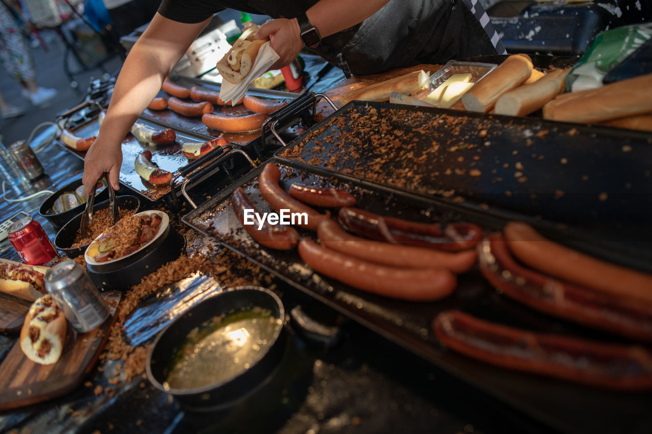 Close-up of man making food on street