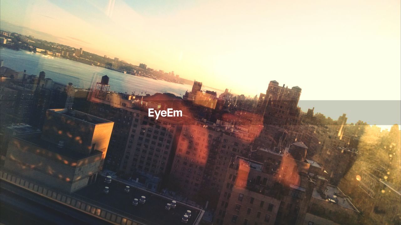 High angle view of city buildings at sunset