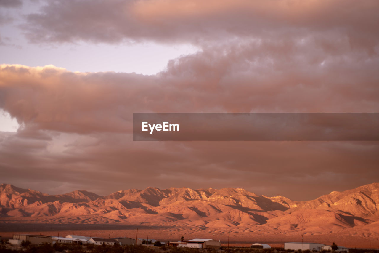 SCENIC VIEW OF SNOWCAPPED MOUNTAIN AGAINST SKY DURING SUNSET