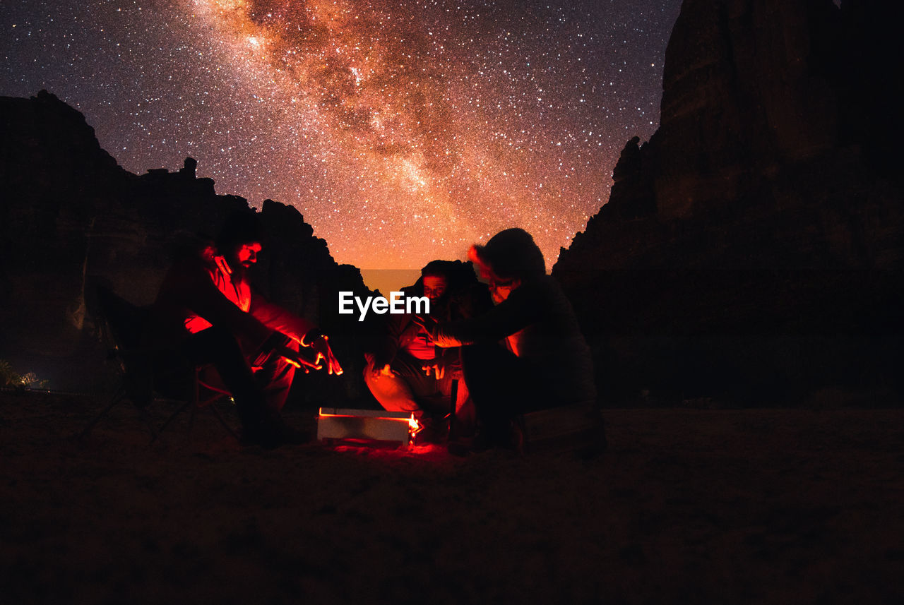 night, star, darkness, sky, space, nature, camping, astronomy, mountain, men, beauty in nature, land, silhouette, bonfire, adventure, adult, exploration, milky way, group of people, galaxy, campfire, leisure activity, scenics - nature, outdoors, activity, travel
