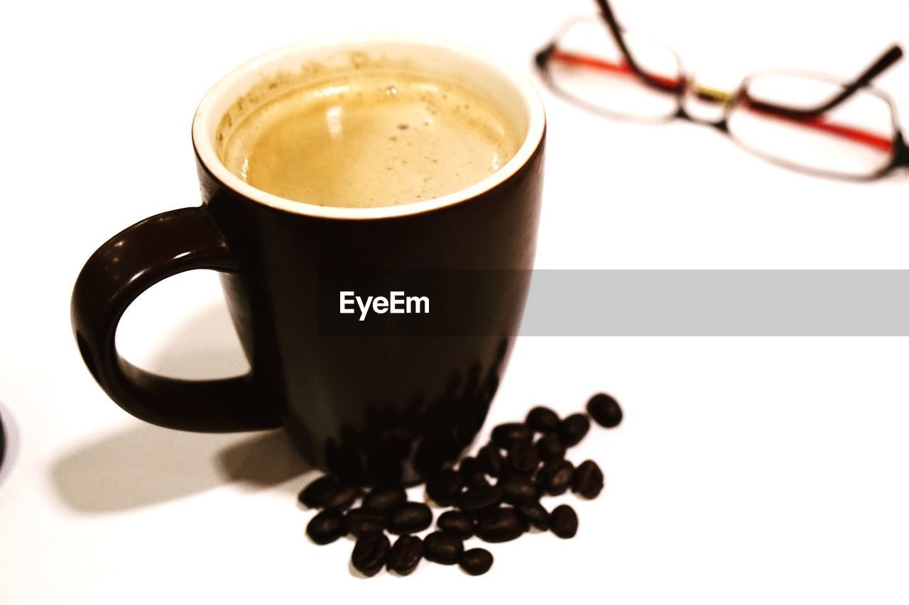 CLOSE-UP OF COFFEE CUP ON WHITE TABLE