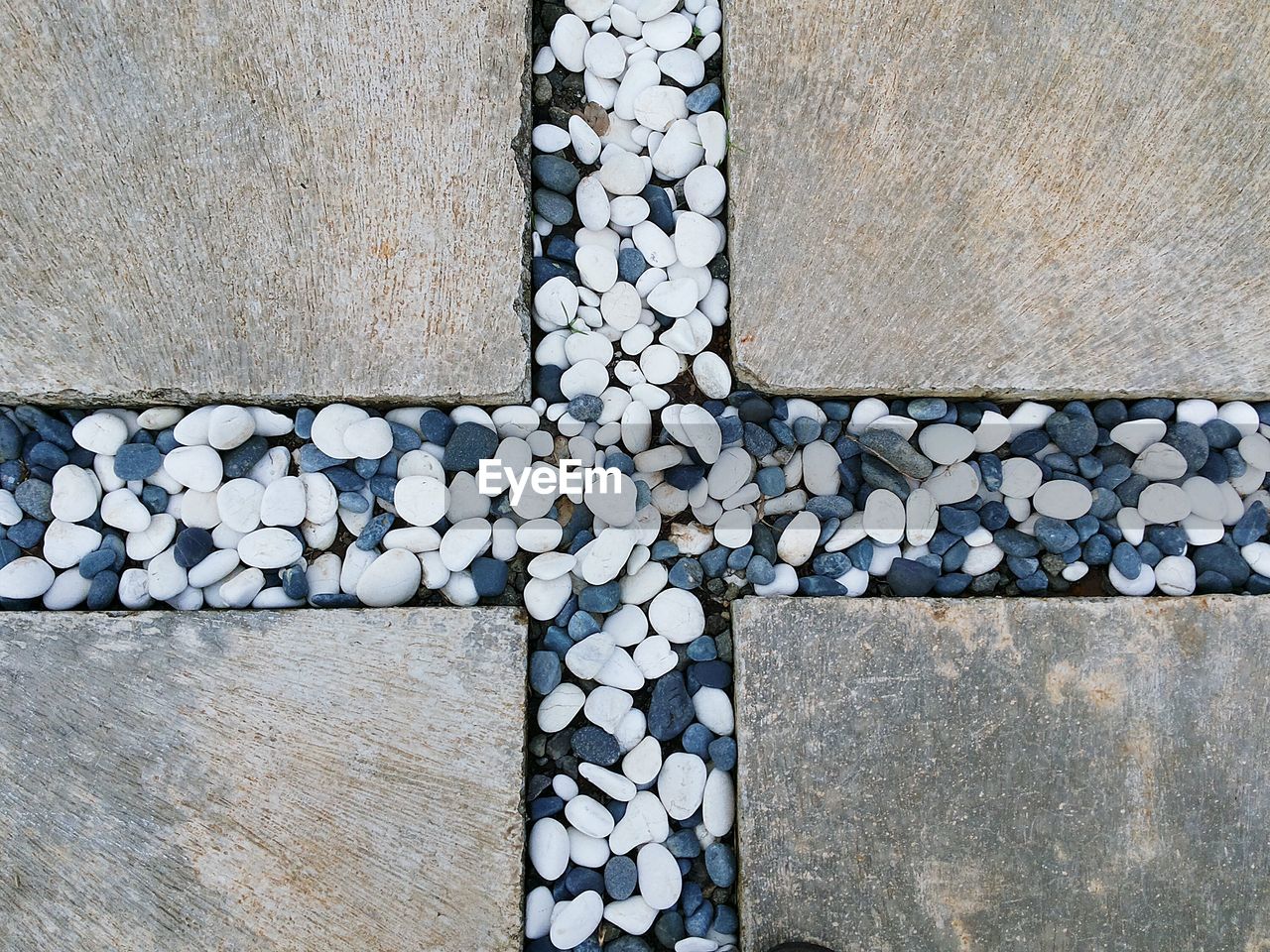 High angle view of stones in cross shape