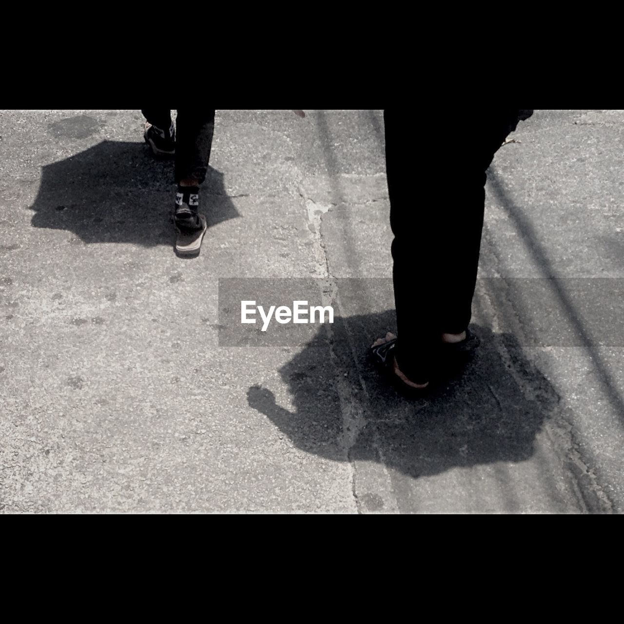 High angle view of people shadow on street while walking