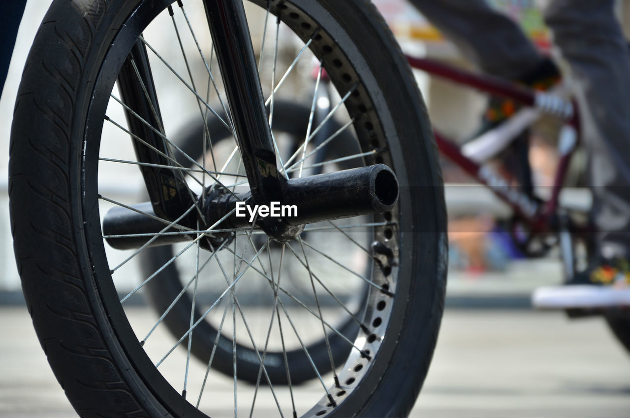 Close-up of bicycle wheel on street