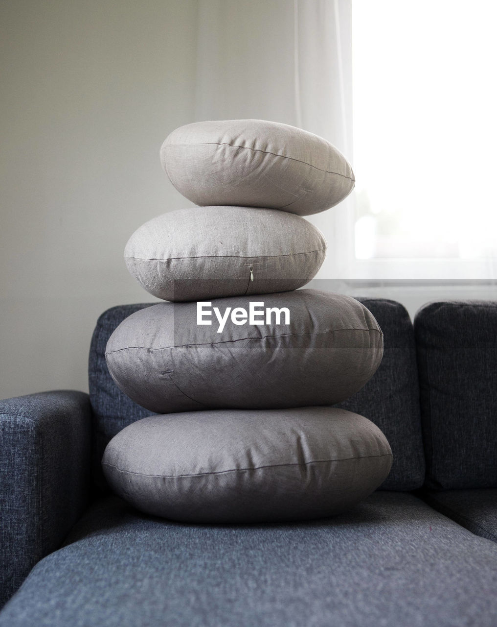 Stack of pillows on sofa at home