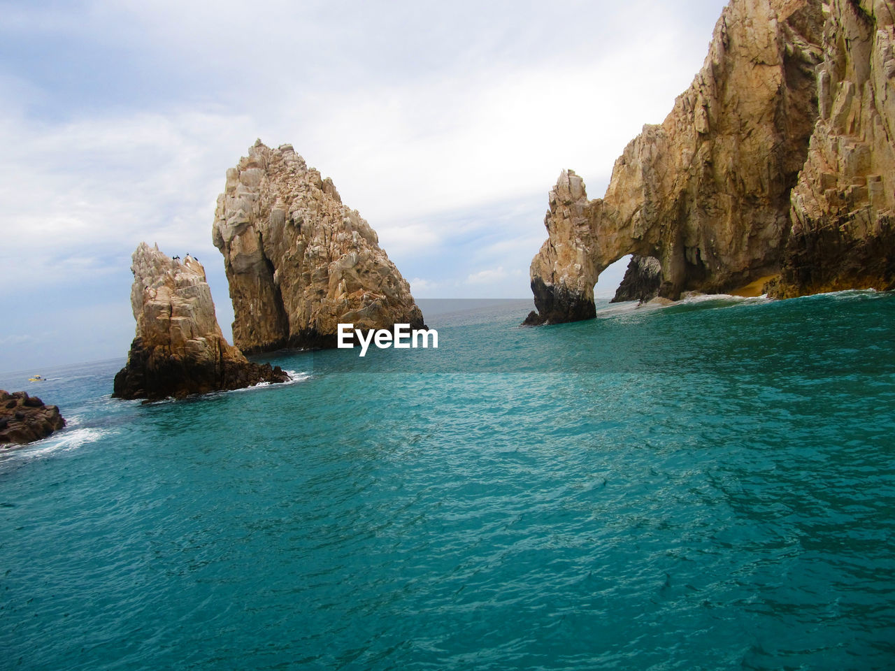 Rocks in sea against sky