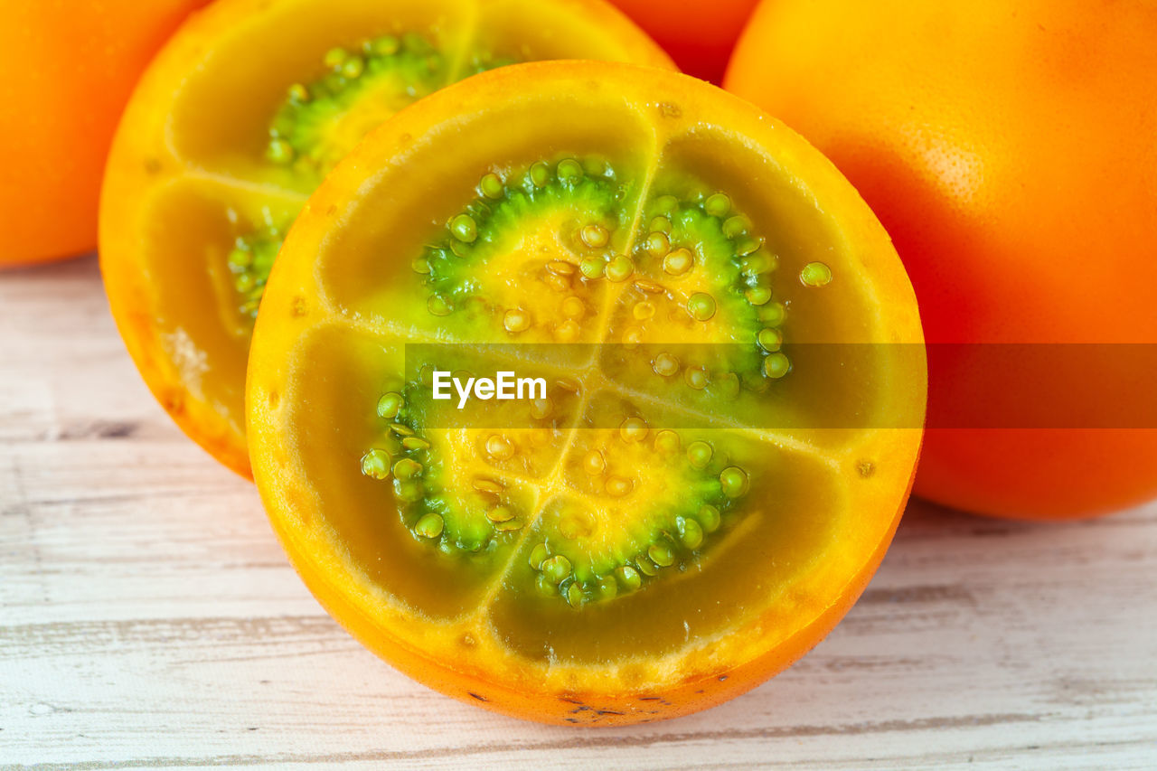 food and drink, food, healthy eating, wellbeing, freshness, fruit, plant, orange color, slice, cross section, produce, indoors, no people, wood, studio shot, close-up, vegetable, yellow, pumpkin, vitamin, citrus fruit, juicy, ripe, organic, table, still life, refreshment