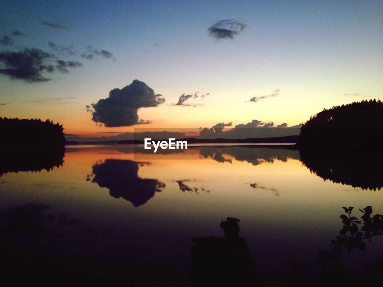 SUNSET OVER CALM LAKE