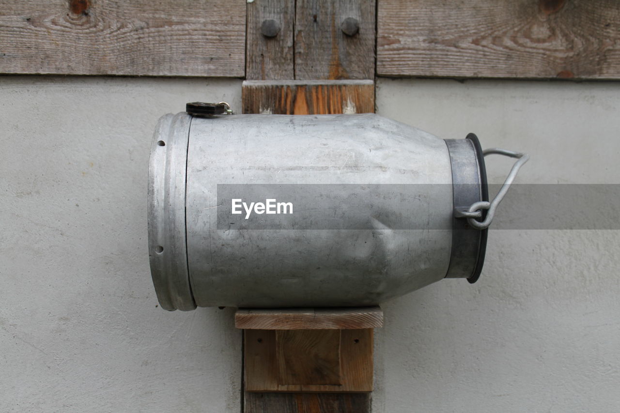 Close-up of milk can against the wall