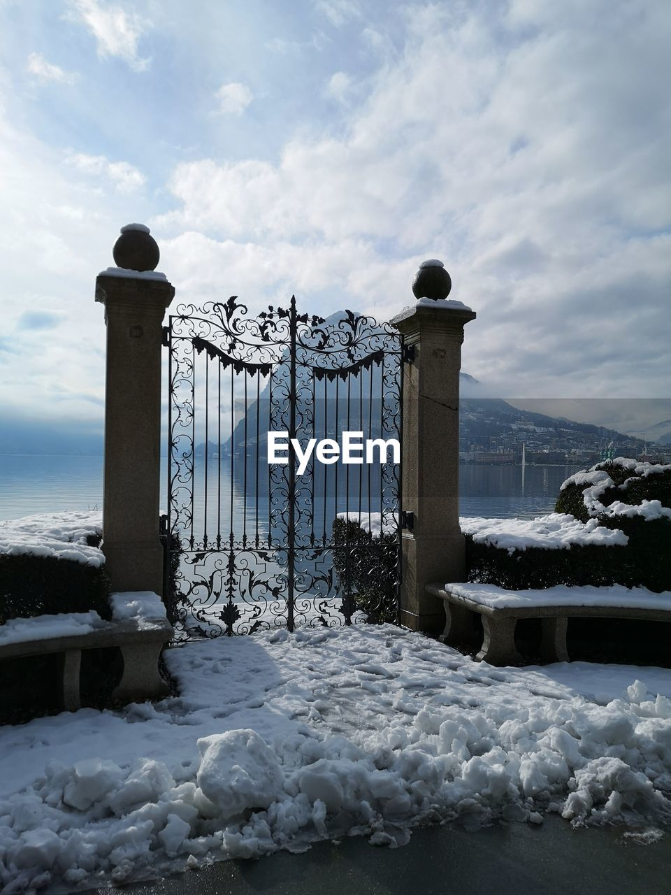 Snow covered railing against sky