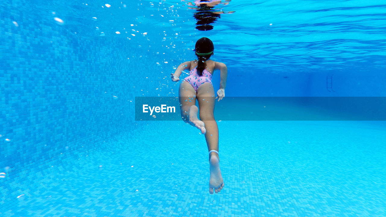 Rear view of woman in swimming pool