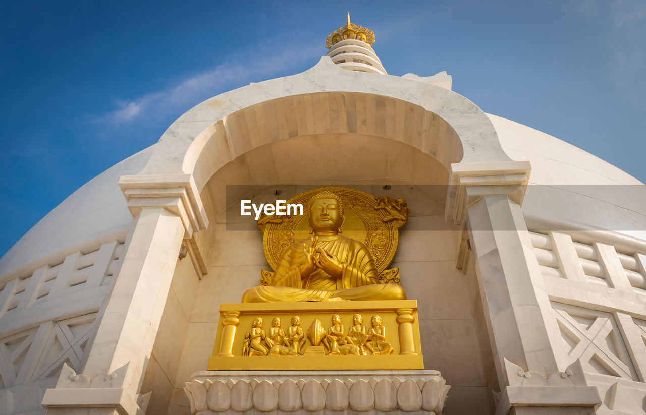 Buddhist stupa isolated with amazing blue sky from unique perspective