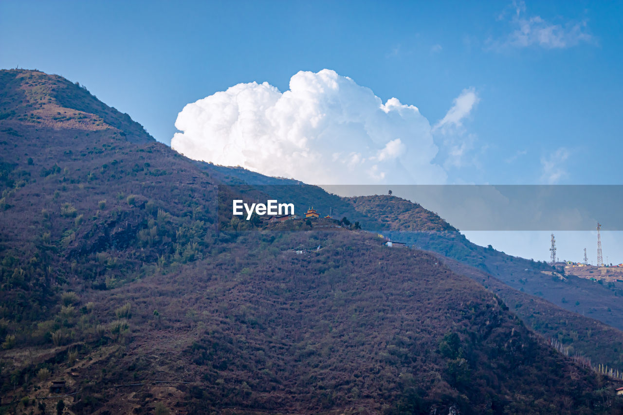 Buddhist monastery situated at mountain foothill at evening 