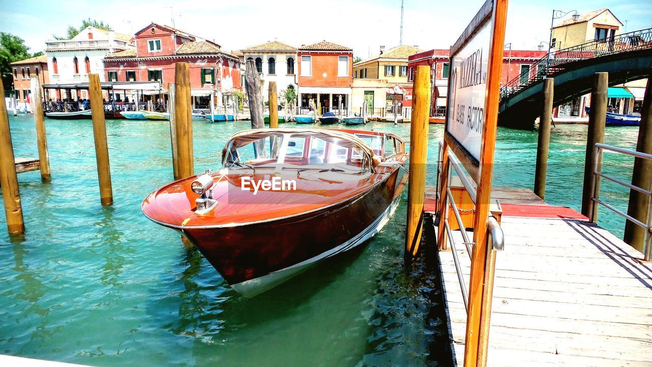 nautical vessel, transportation, mode of transport, moored, architecture, built structure, building exterior, water, day, canal, no people, outdoors, wooden post, nature, sky, gondola - traditional boat