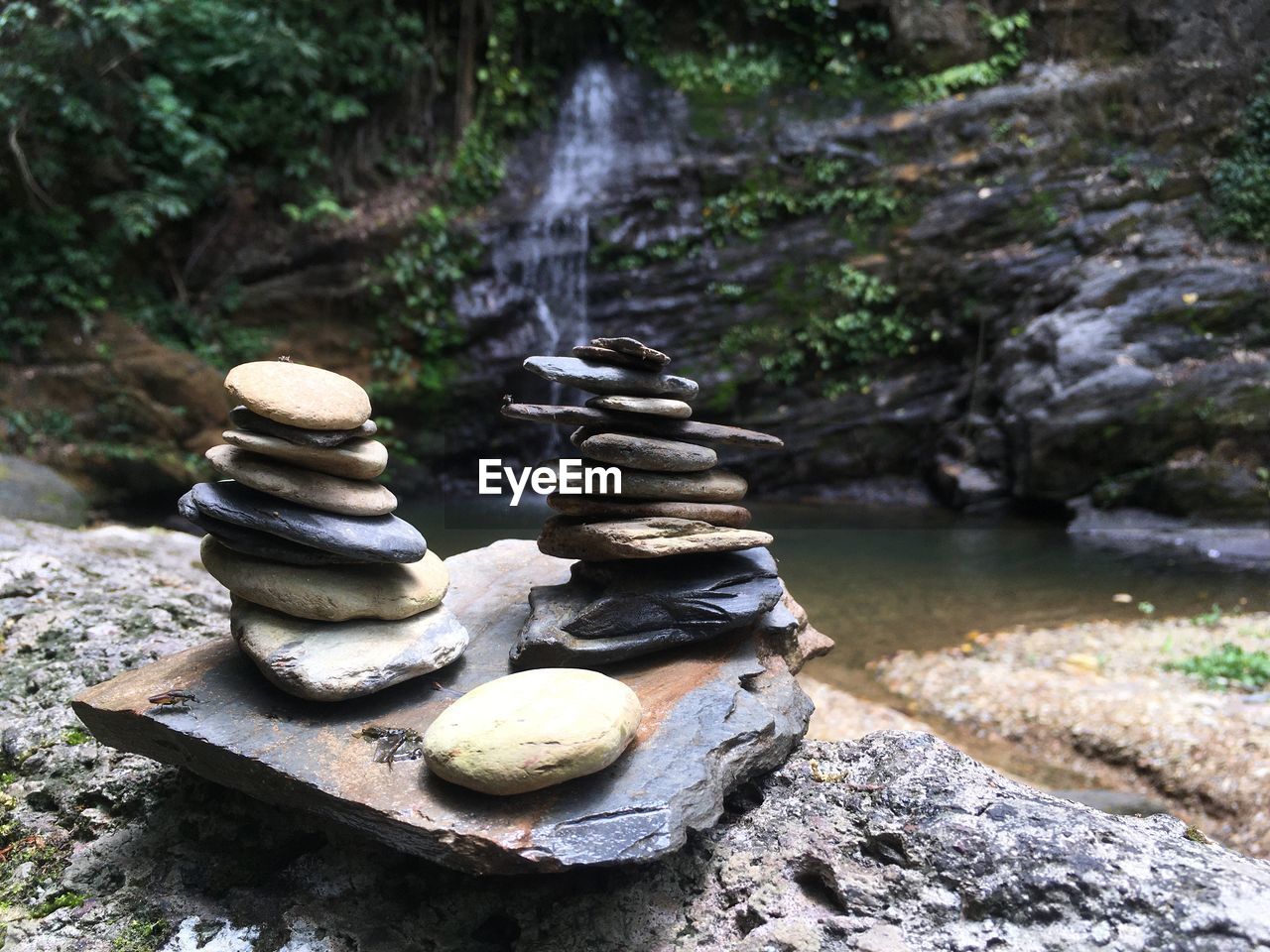 STACK OF STONES ON ROCK IN FOREST