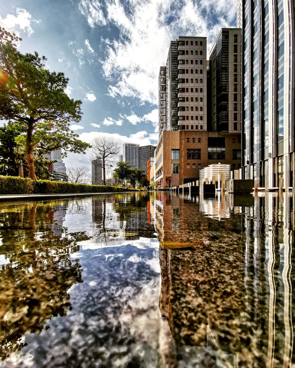 REFLECTION OF BUILDING IN PUDDLE