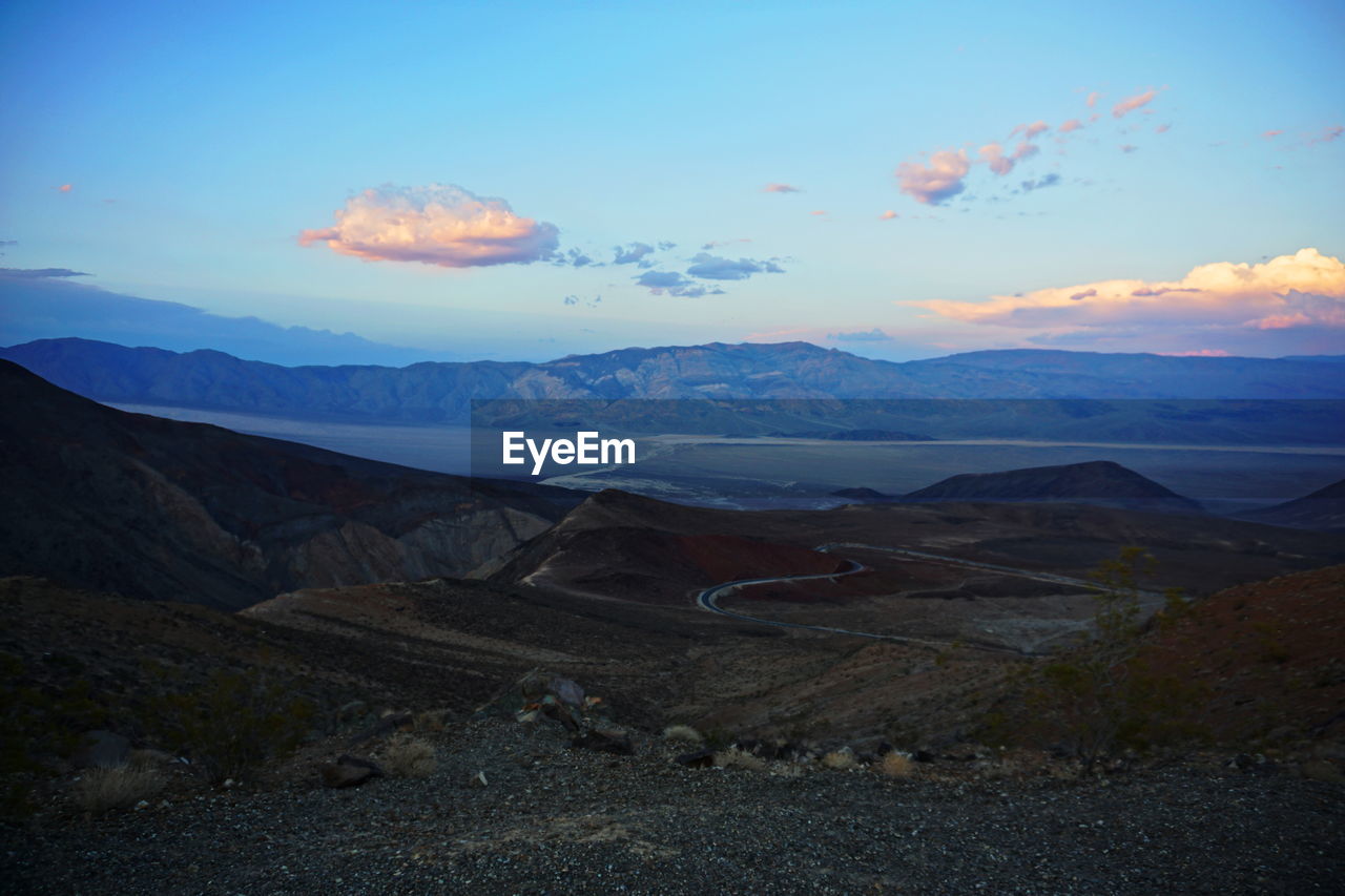SCENIC VIEW OF LANDSCAPE AND MOUNTAINS AGAINST SKY DURING SUNSET