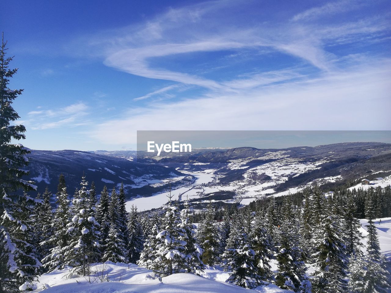 Scenic view of landscape against sky during winter