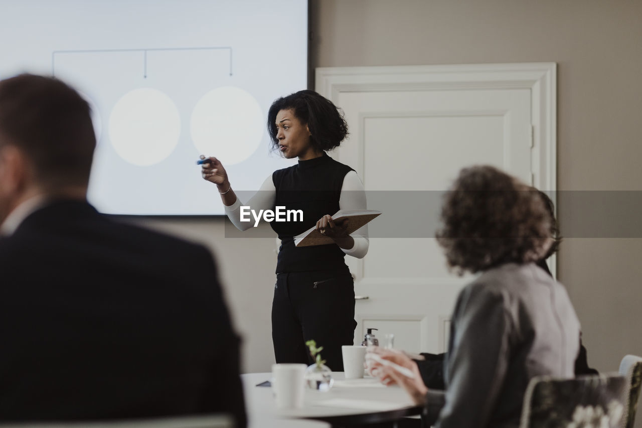 Businesswoman explaining in meeting at corporate office