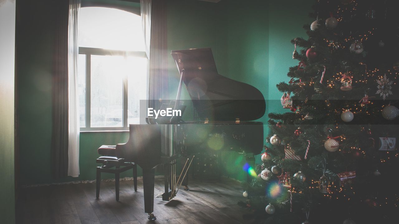 Piano table by christmas tree at home