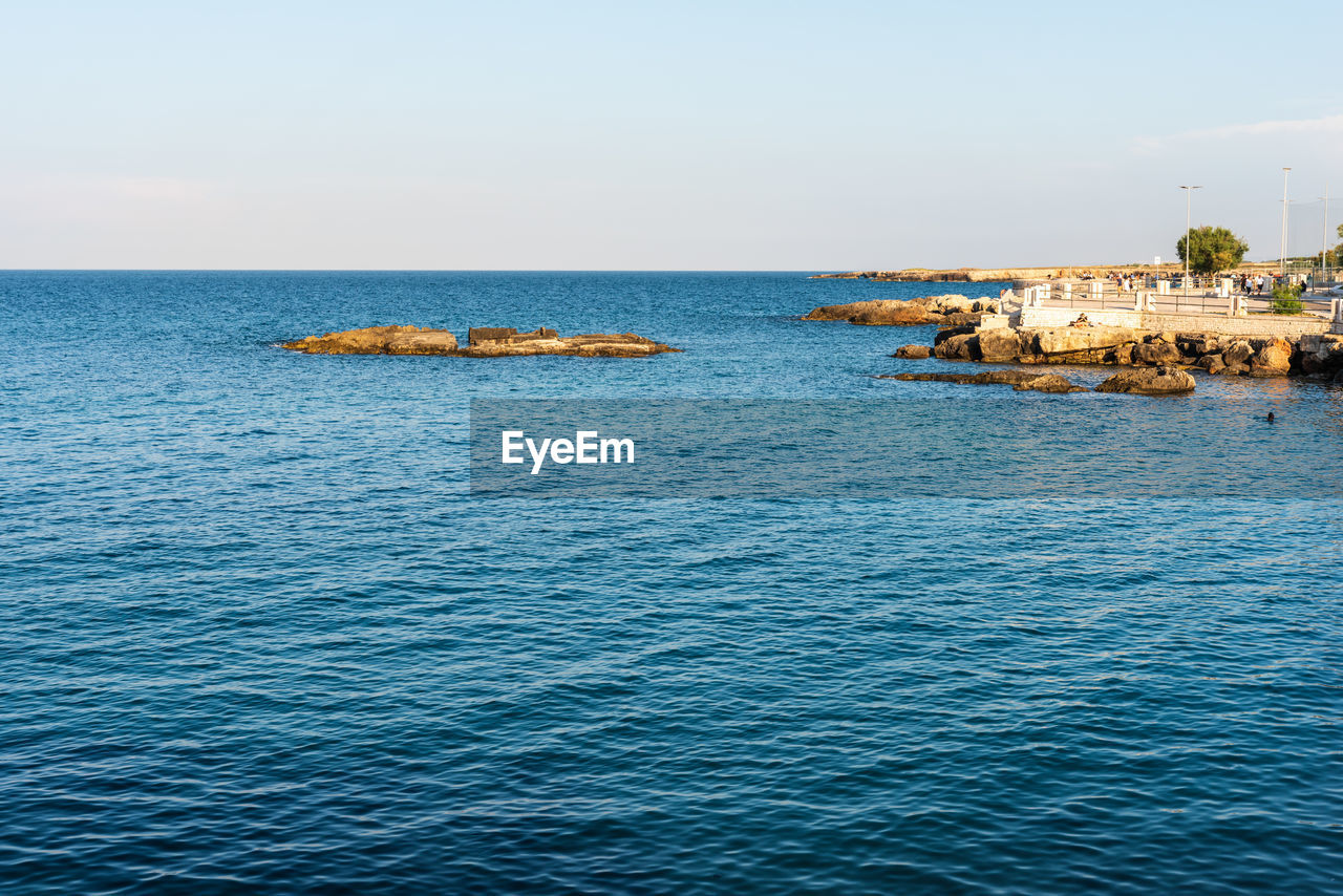 BOAT IN SEA AGAINST CLEAR SKY