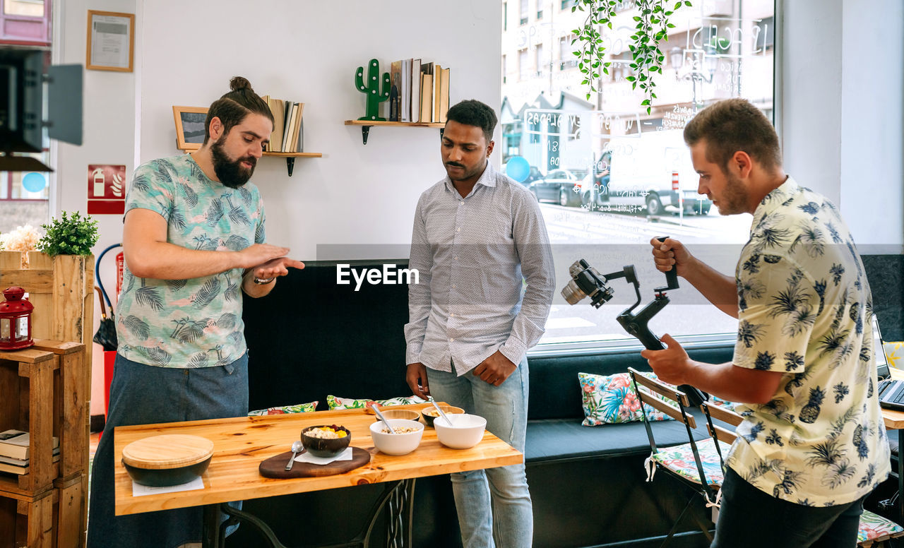 People recording video in restaurant