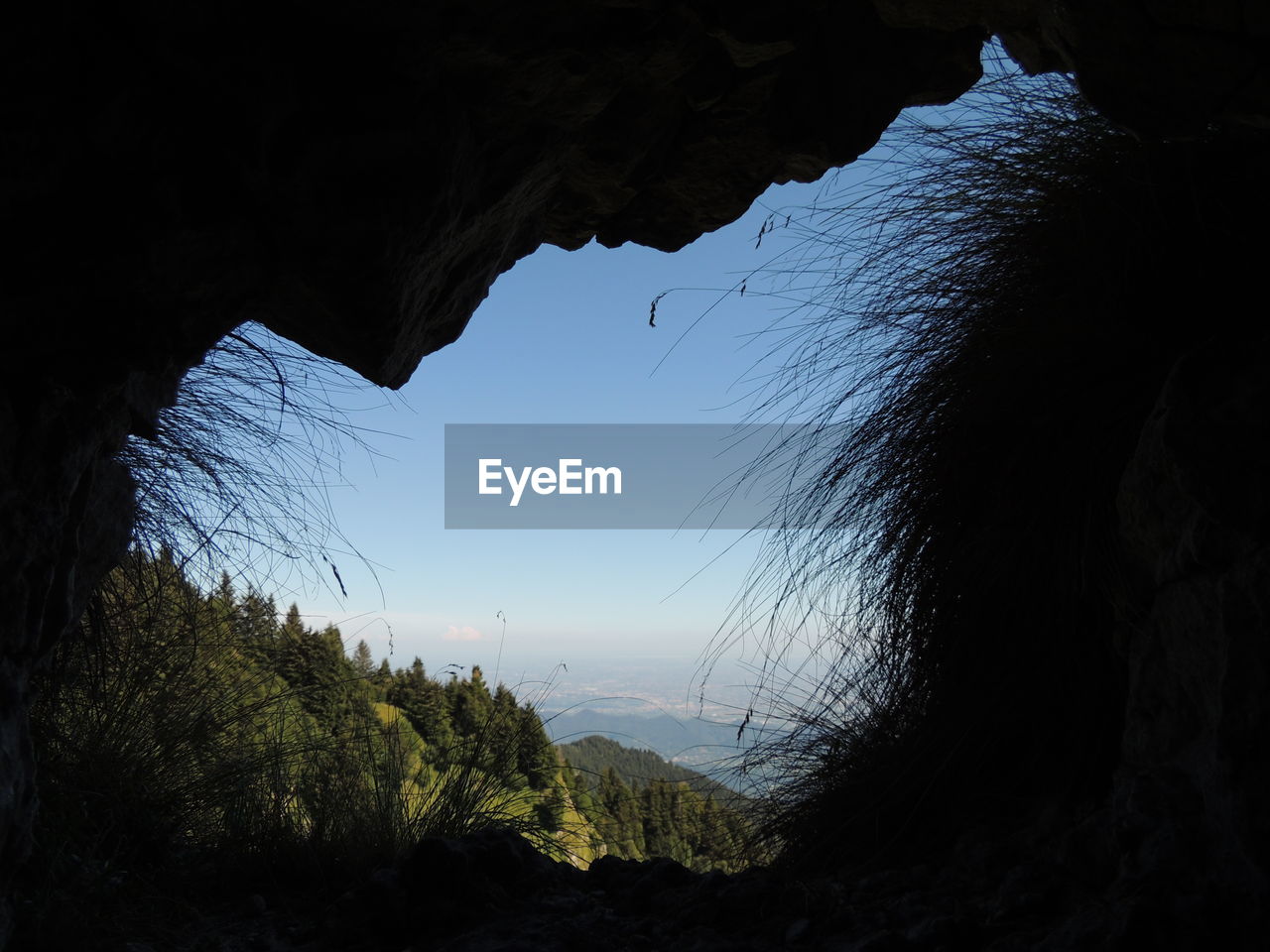 SCENIC VIEW OF SILHOUETTE MOUNTAINS AGAINST SKY SEEN FROM CAVE