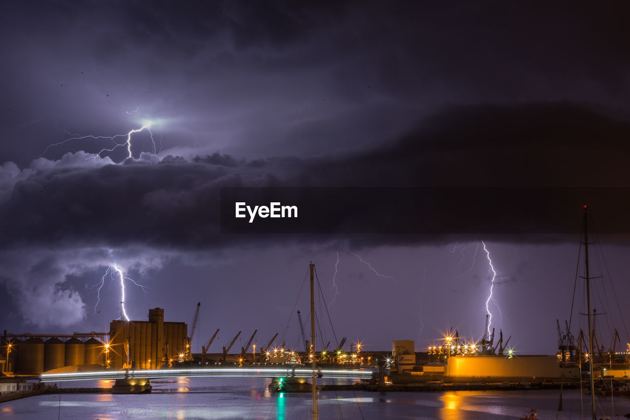 Panoramic view of lightning over sea against sky at night during the storm