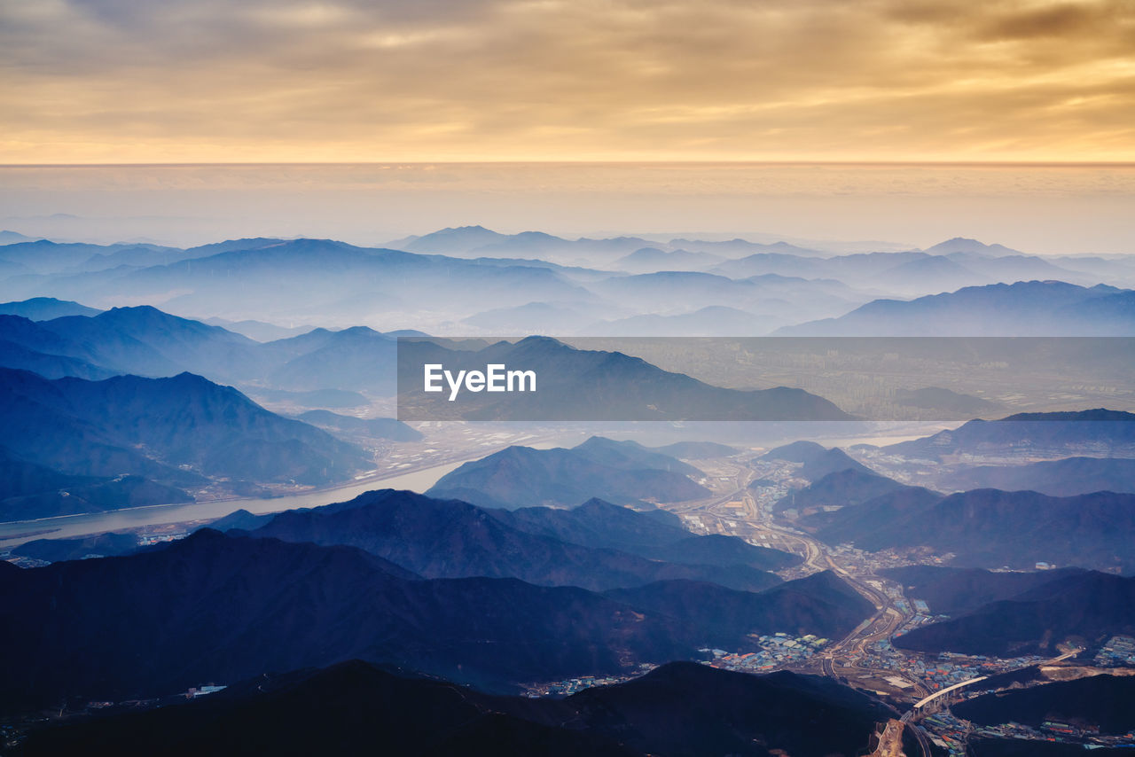 Scenic view of mountains against sky at sunset