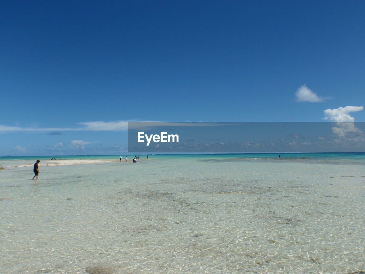 Scenic view of beach against blue sky