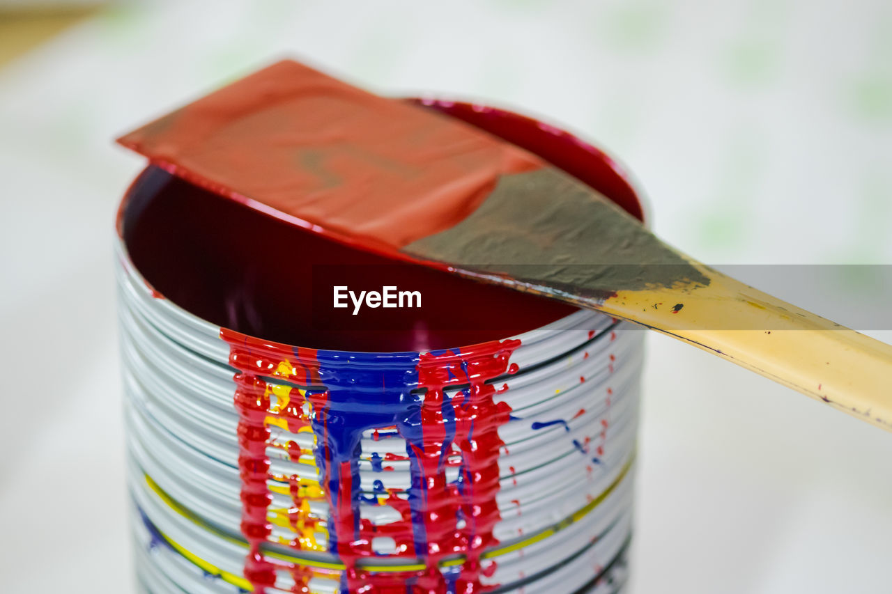 Close-up of paint can with tool