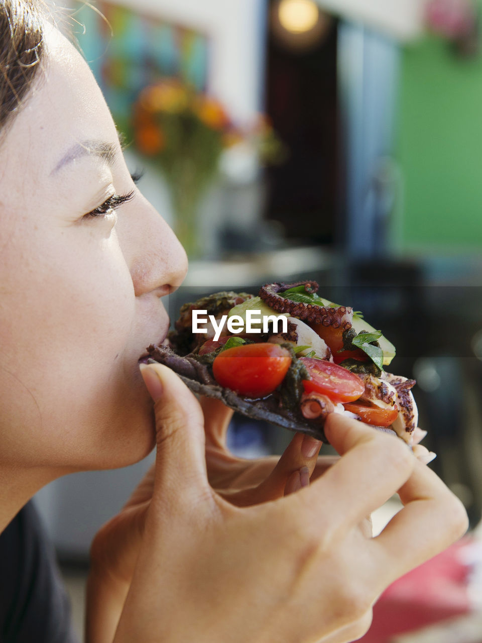 A japanese lady eats a seafood taco in san diego
