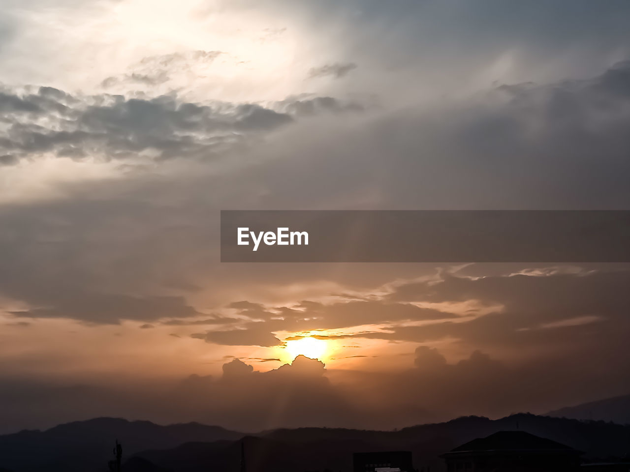 LOW ANGLE VIEW OF SILHOUETTE MOUNTAIN AGAINST ORANGE SKY