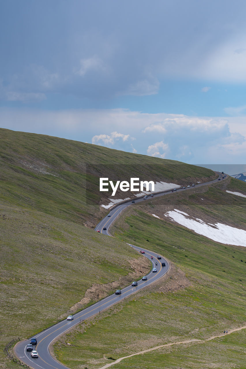 High angle view of road by land against sky