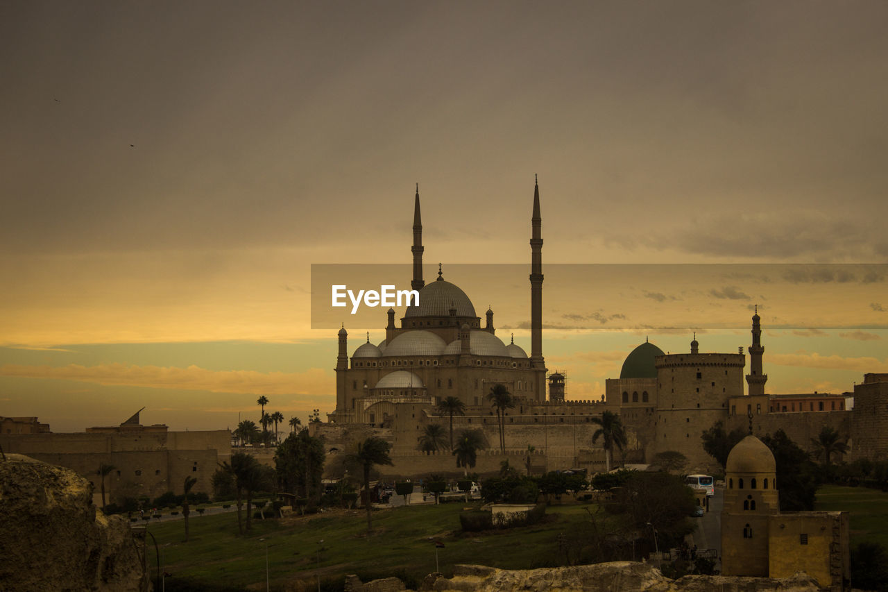 Historical mosque against sky during sunset