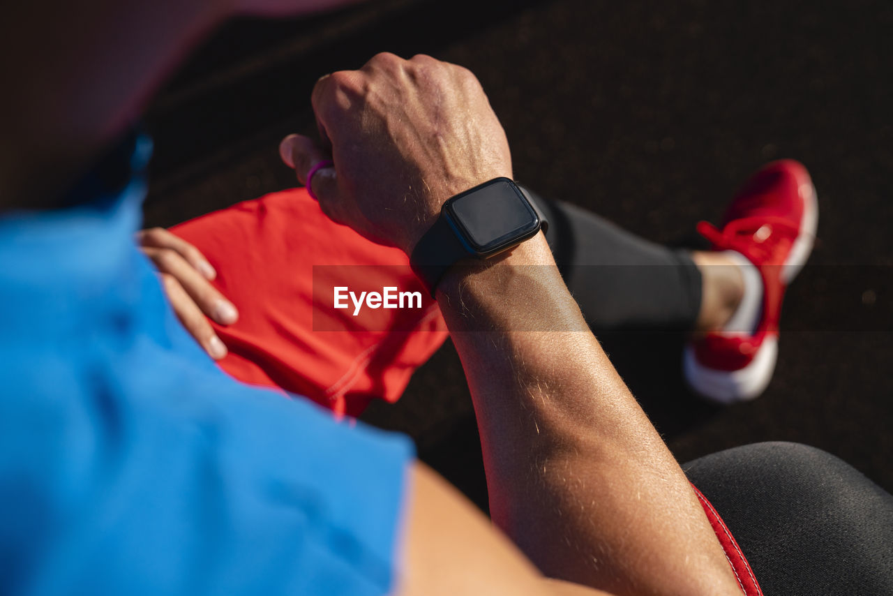 Athlete checking time on smart watch