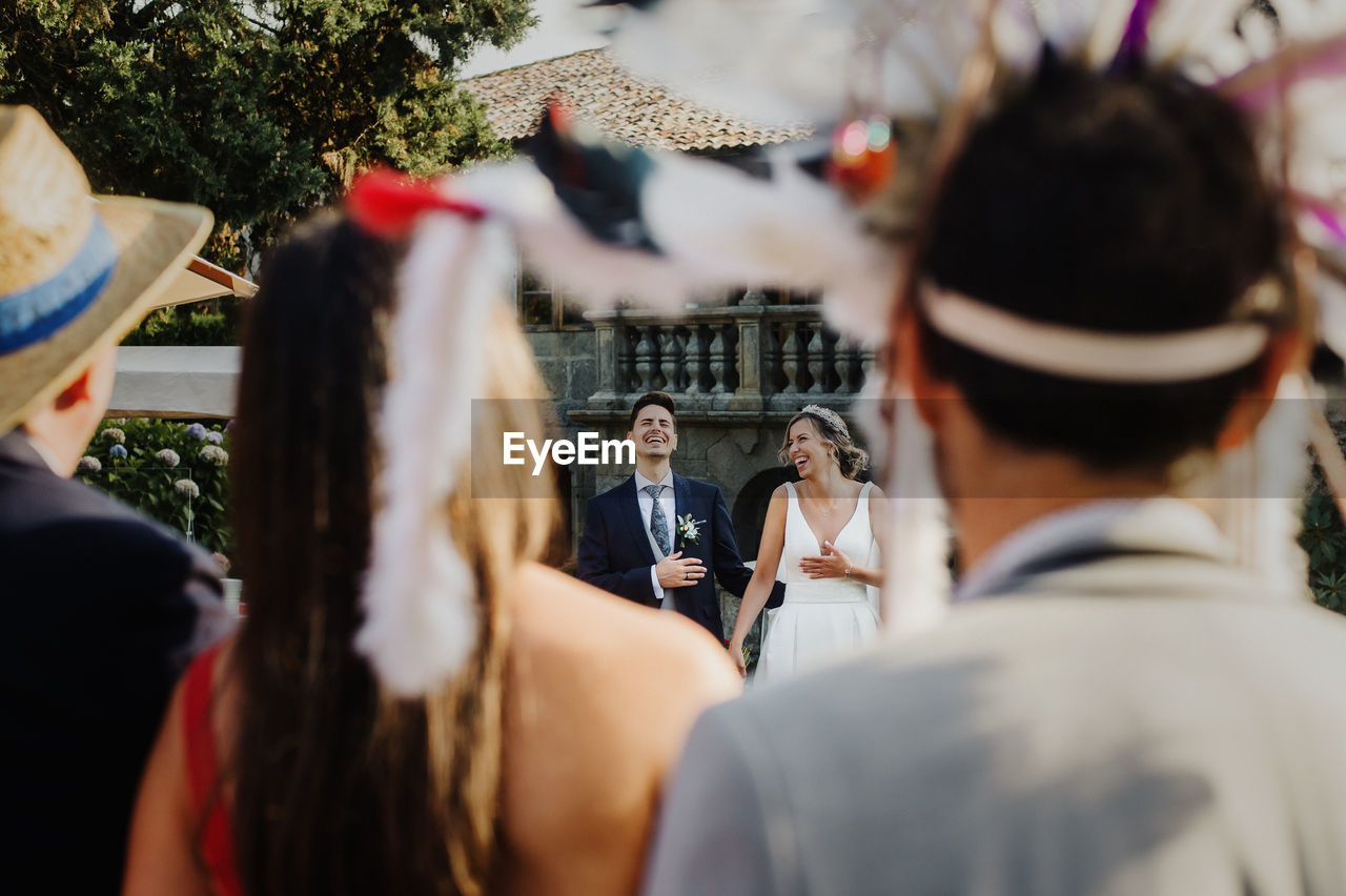 Couple seen through people during wedding