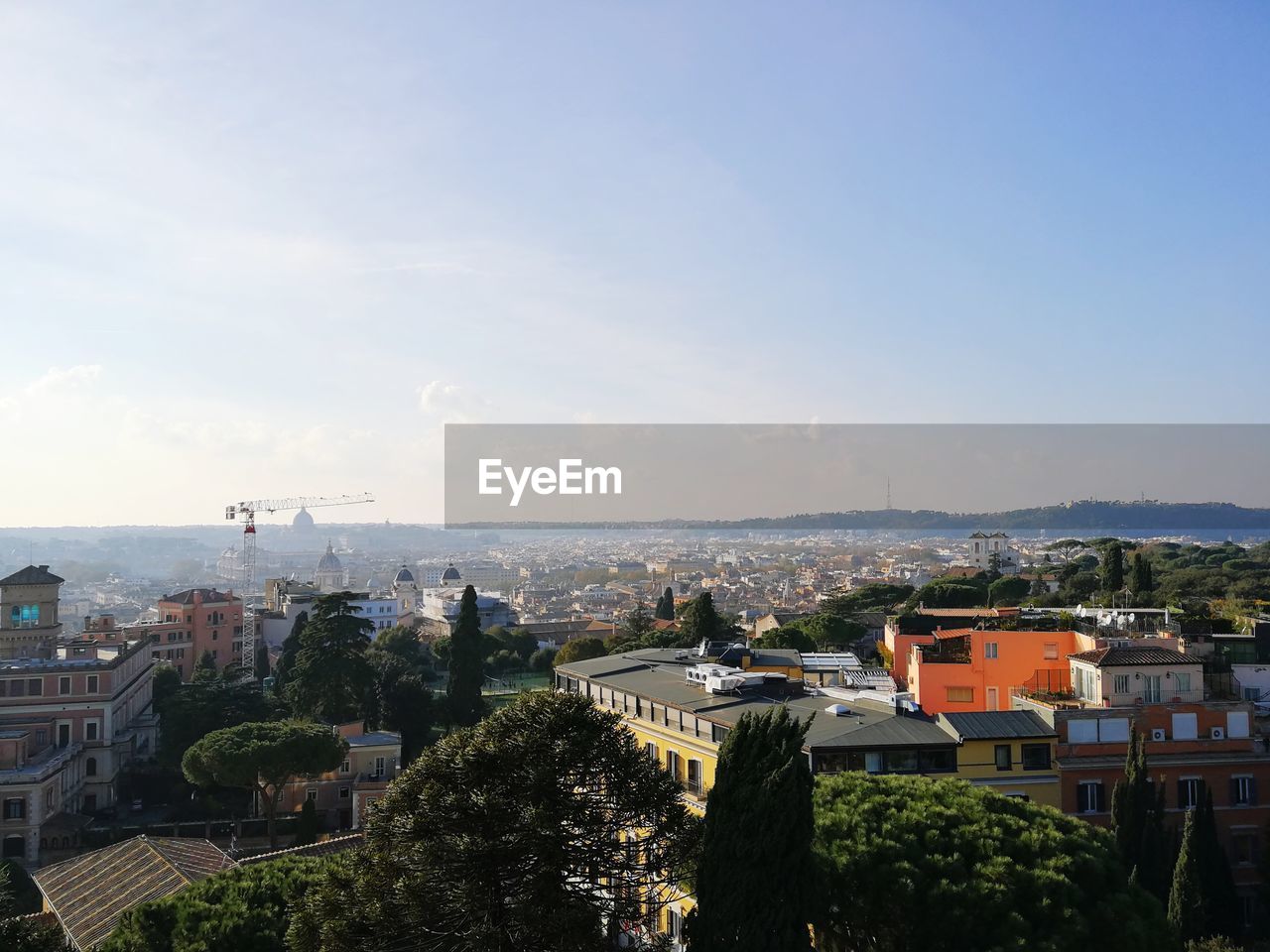 High angle view of buildings in town against sky
