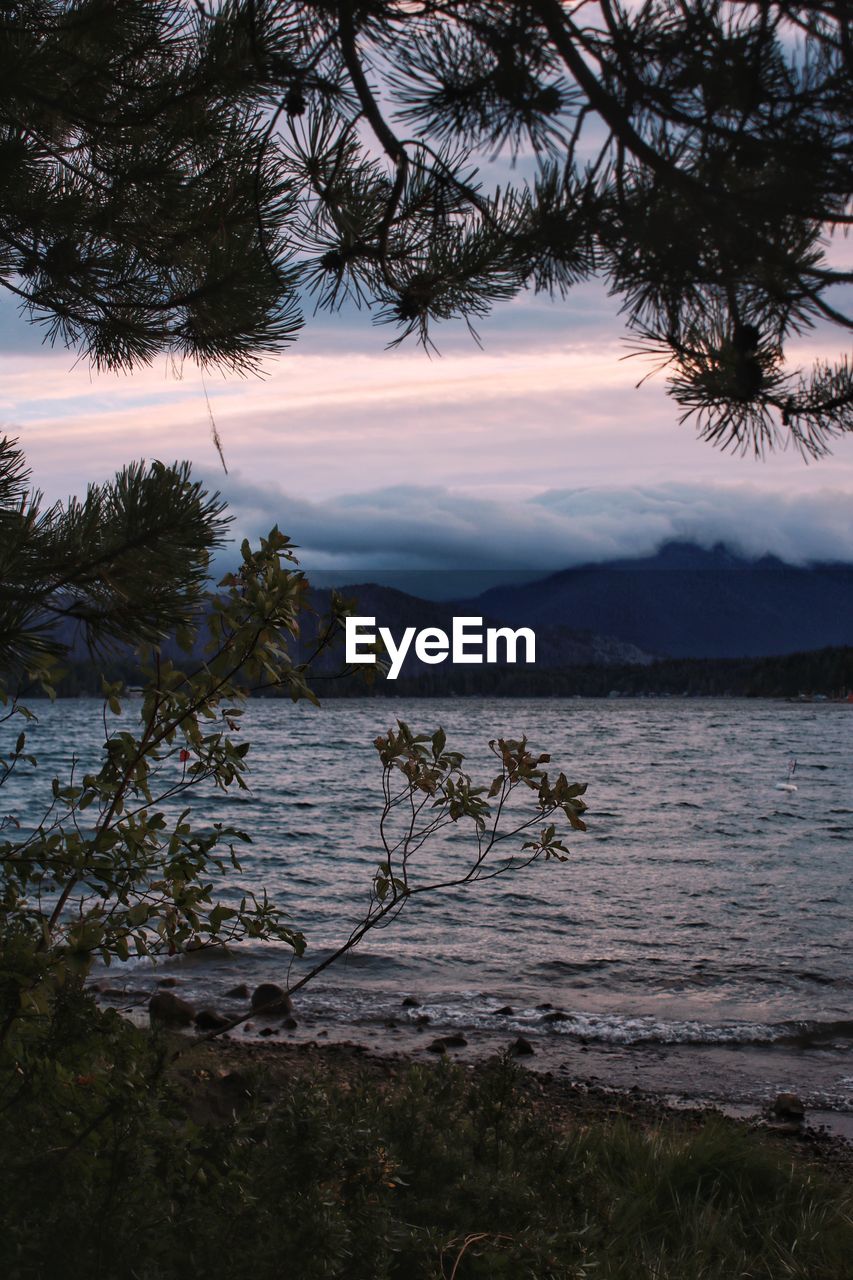 Scenic view of lake against sky at sunset