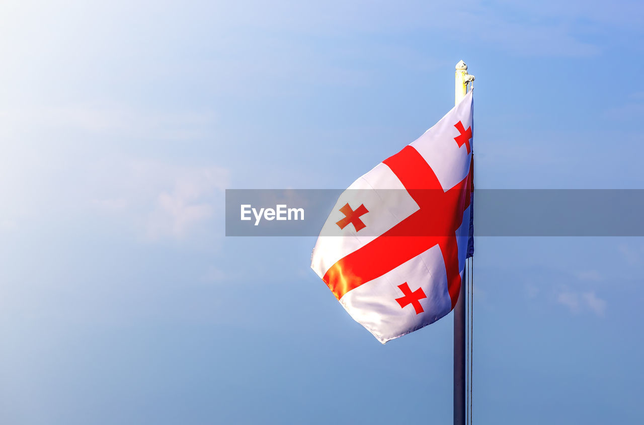 Flag of georgia against the blue sky