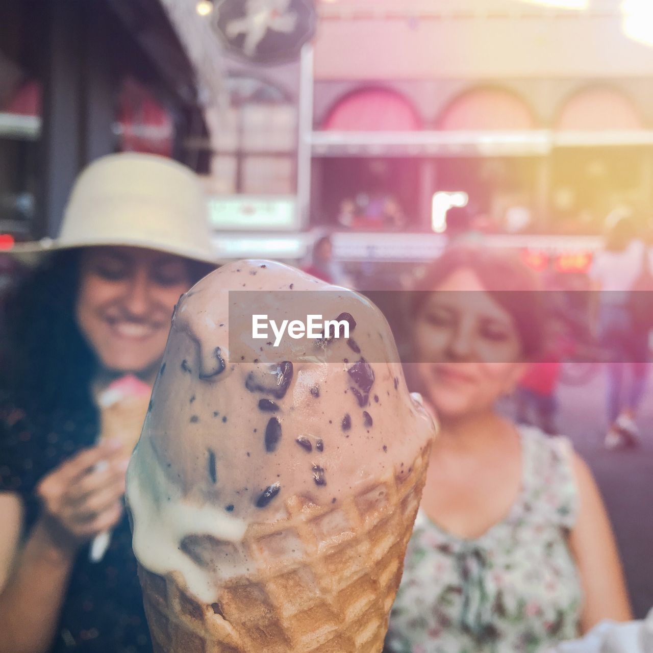 Close-up of smiling young woman with ice cream