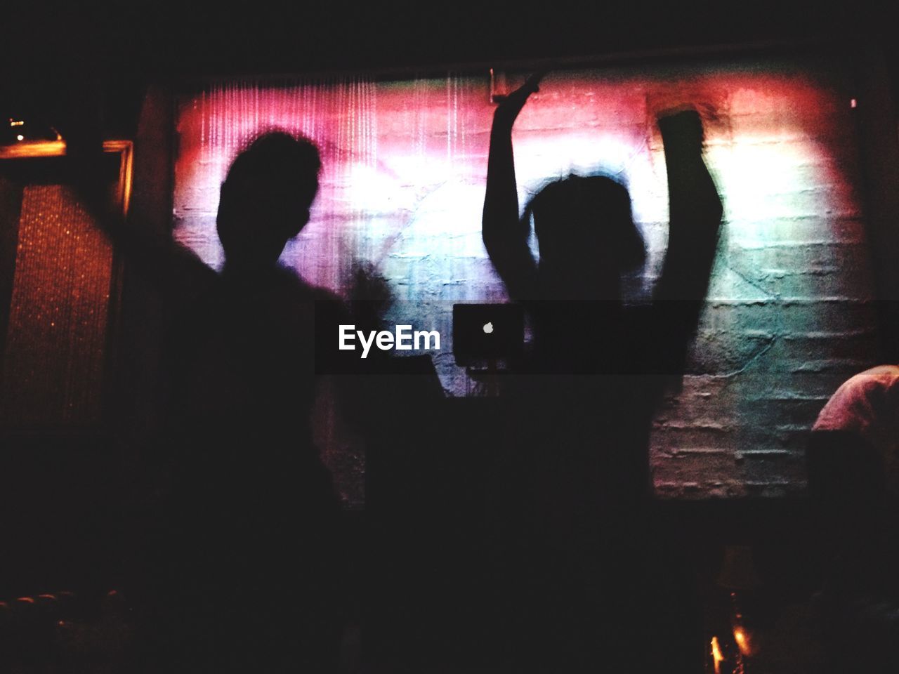 Silhouette people dancing in nightclub