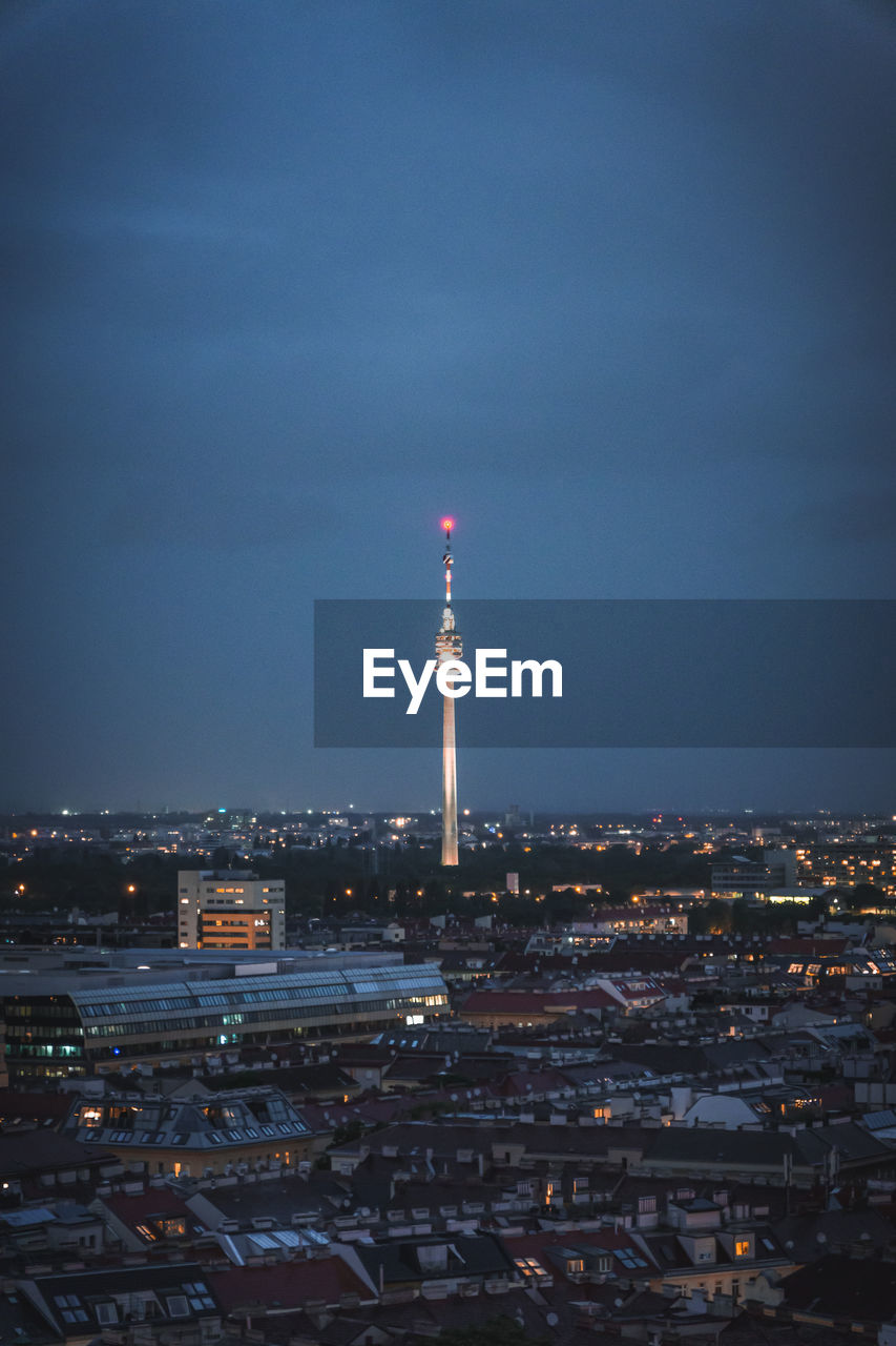 Illuminated cityscape against sky at night