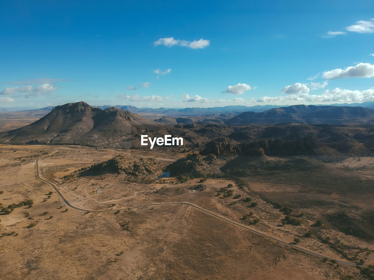 Scenic view of arid landscape against sky