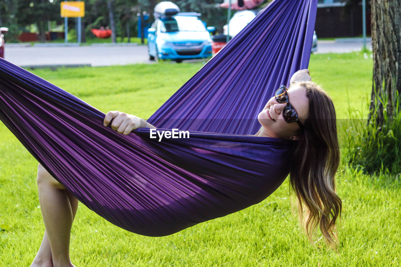 Young woman lying in hammock