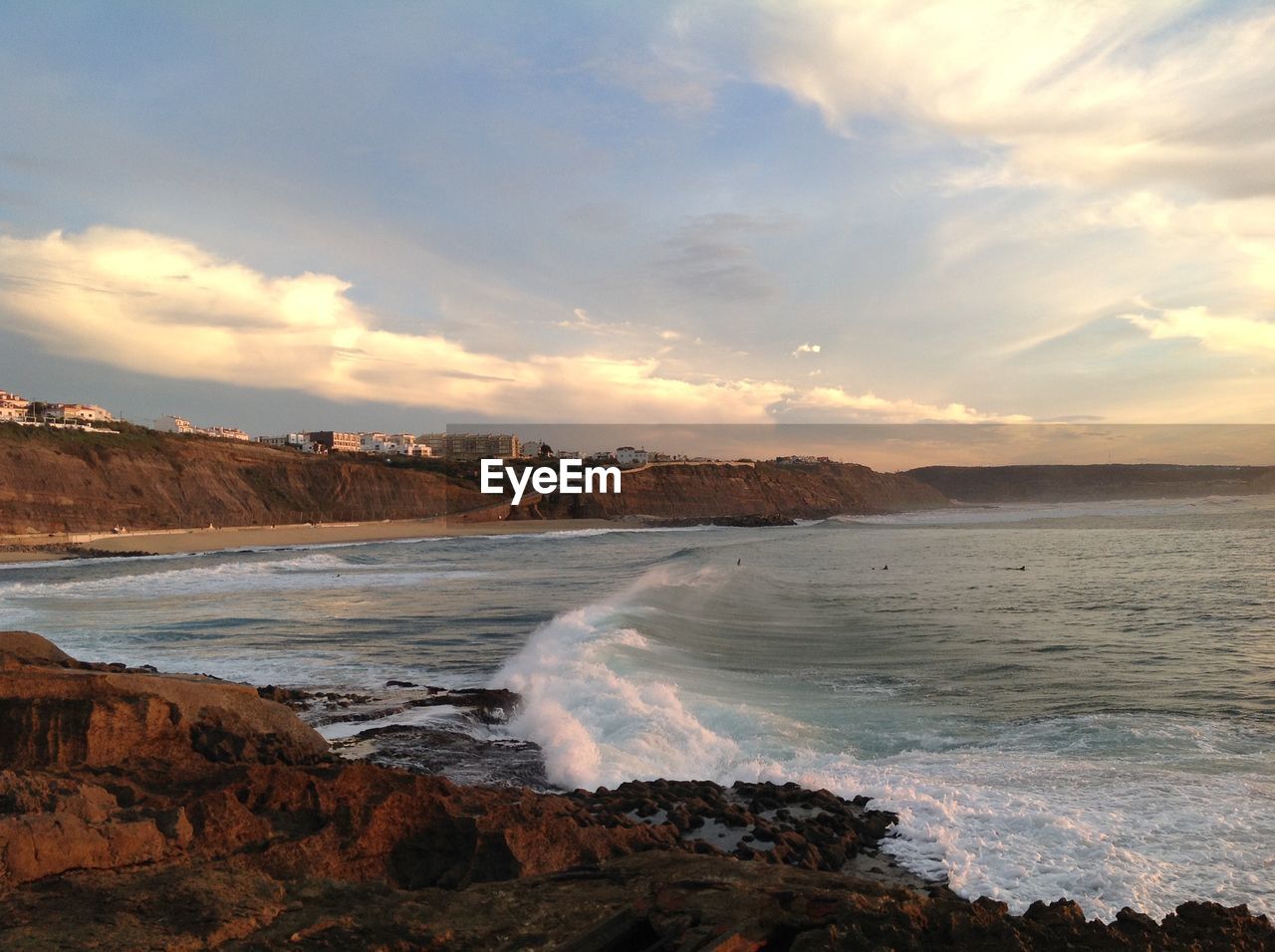 View of beach against cloudy sky