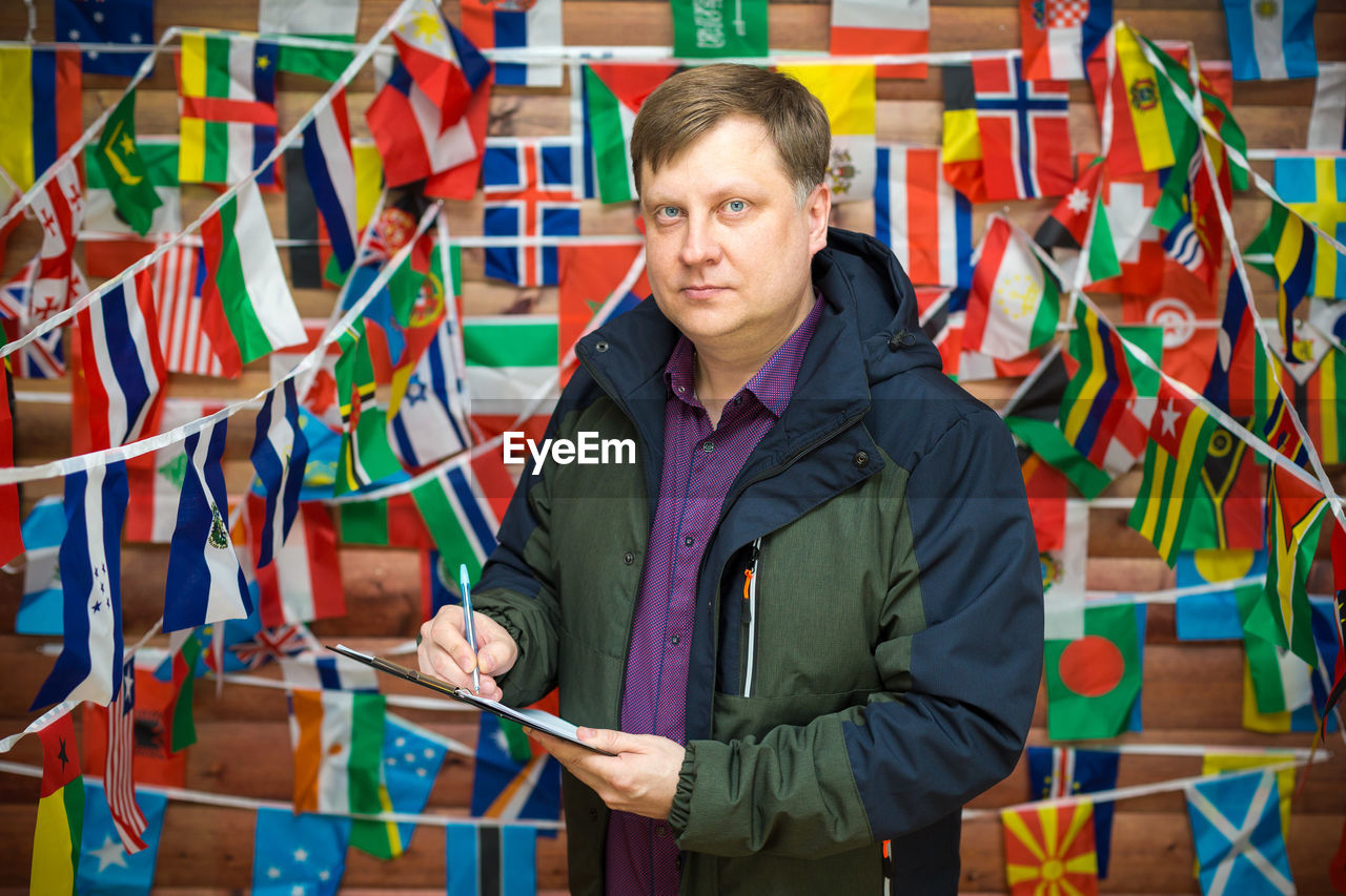 Portrait of man holding multi colored umbrella