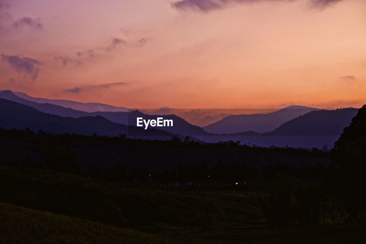 Scenic view of mountains against sky during sunset